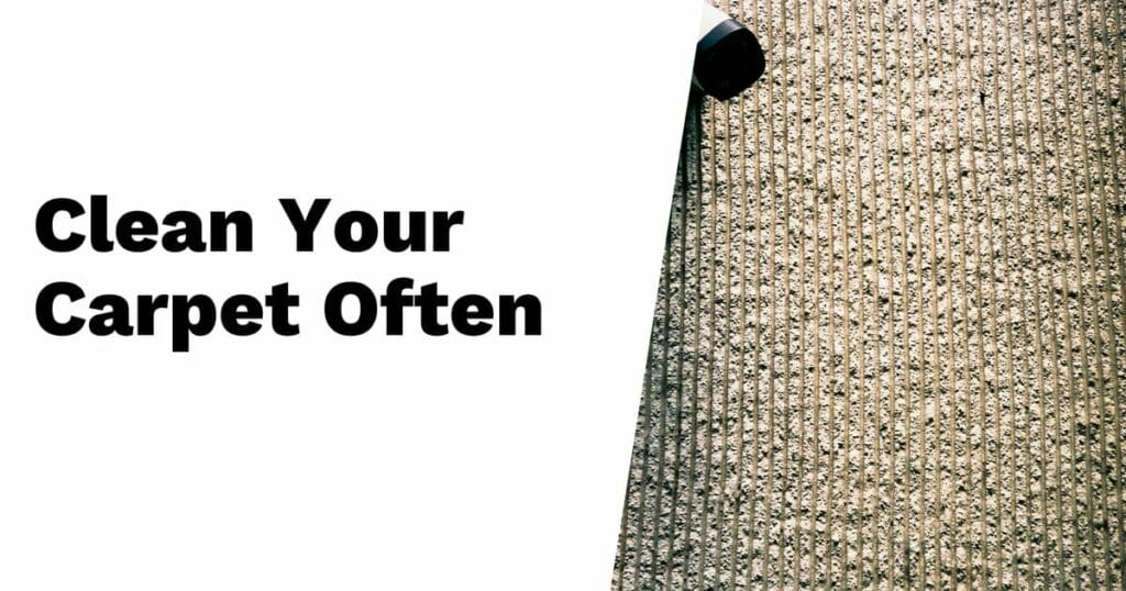A vacuum cleaner moves over a carpet with the text “Clean Your Carpet Often” displayed on the left side of the image.